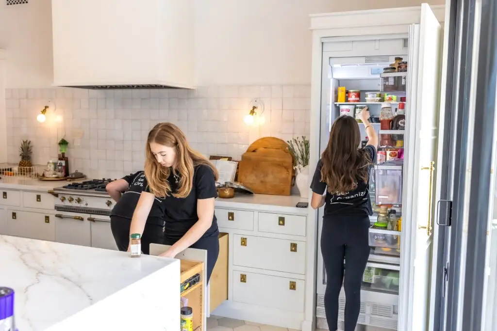 organizers decluttering the kitchen before a m ove