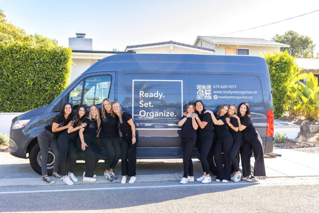 team picture of Ready Set Organize organizers in front of branded van